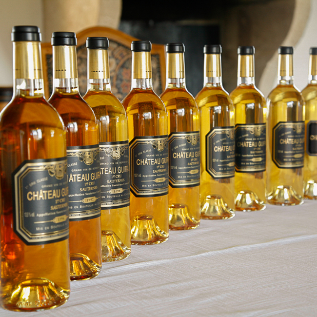 éventail de couleurs du Château Guiraud - dizaine de bouteilles acollées